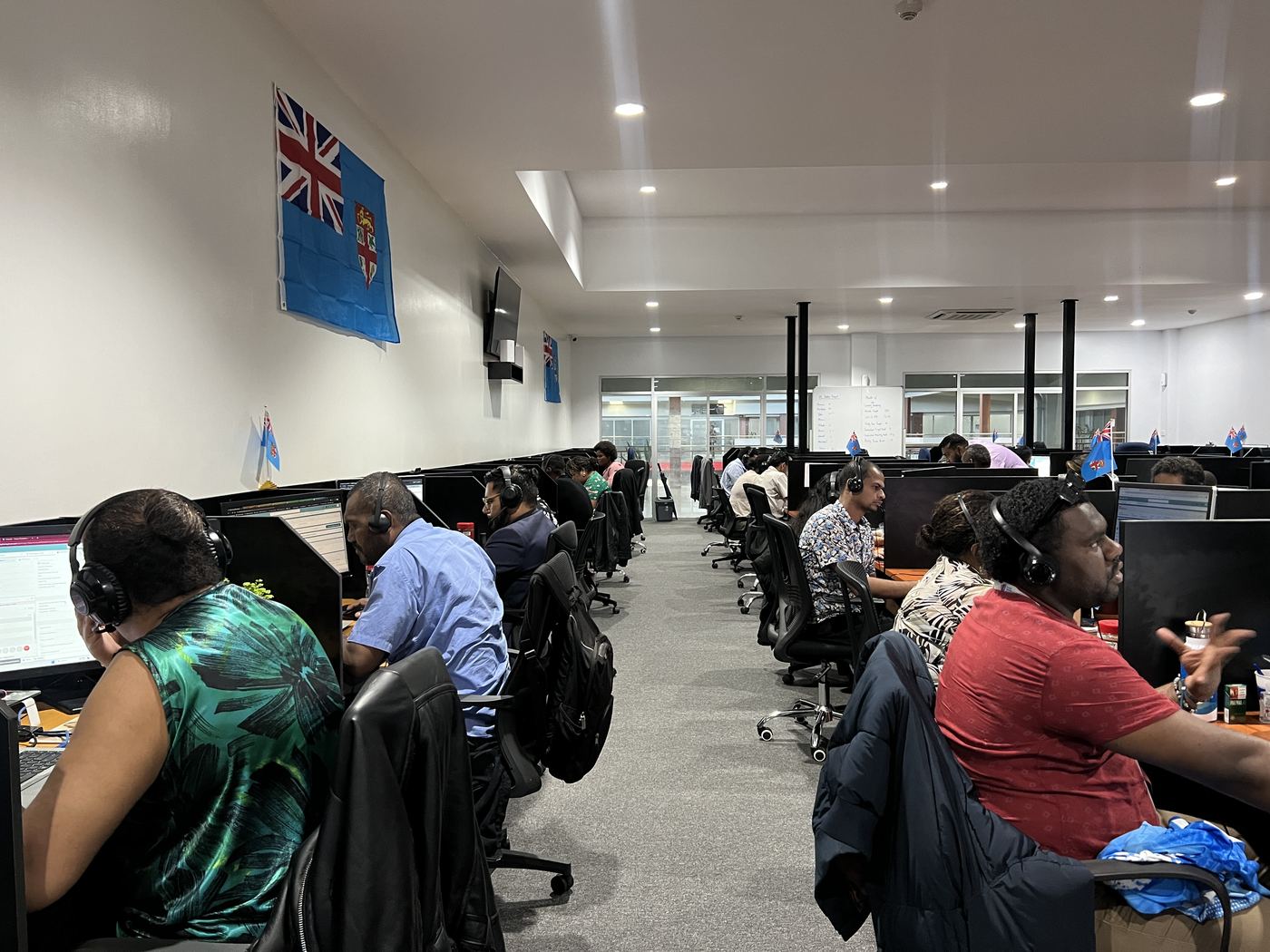 PCS Suva office wide angle with Fiji flags