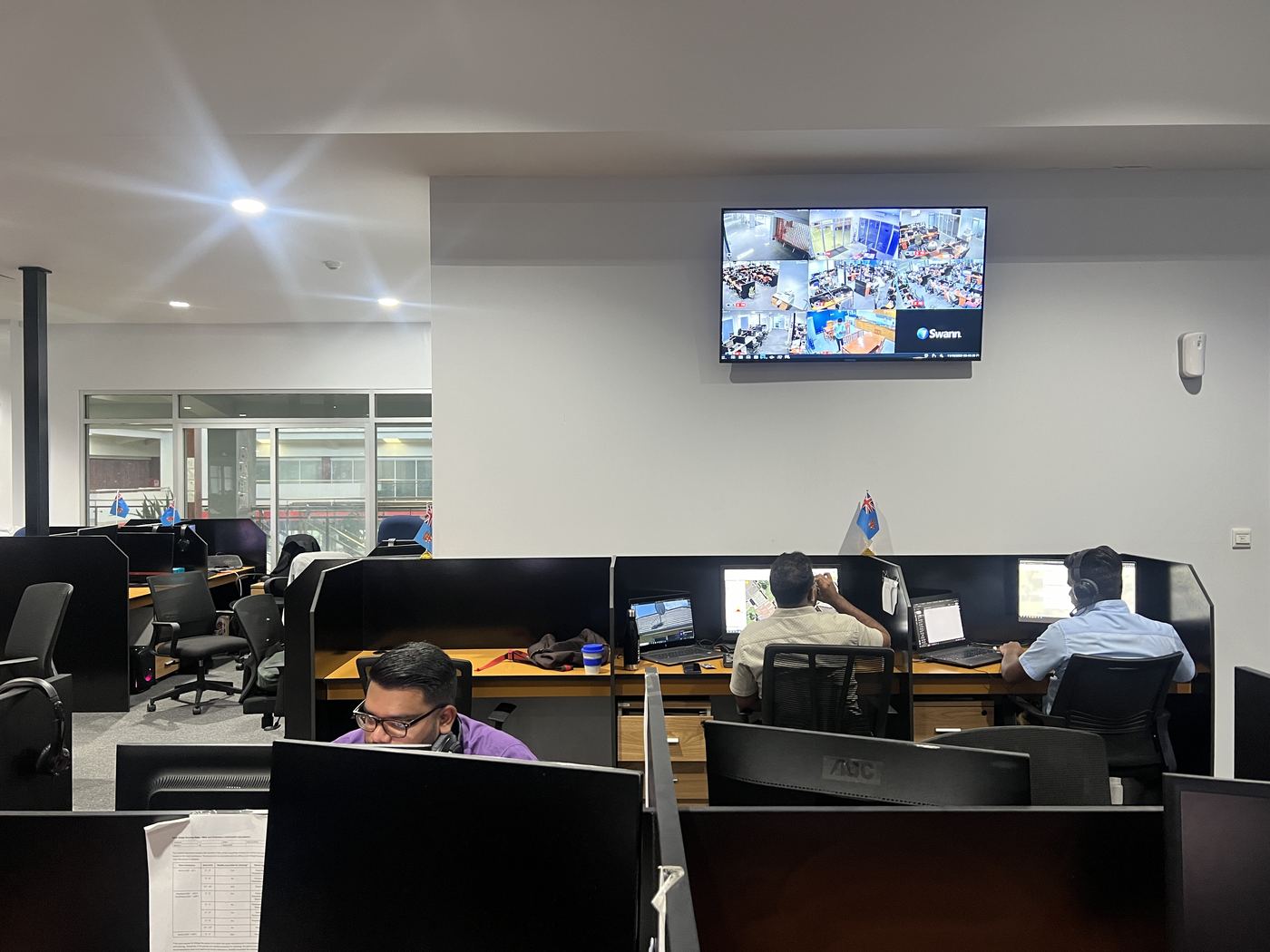 PCS Suva team at workstations with supervisor on floor