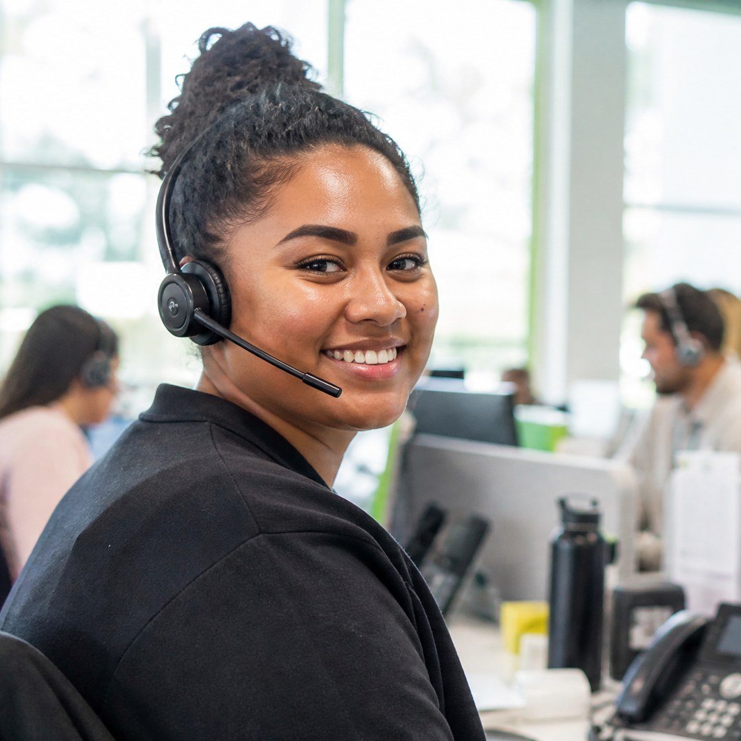 PCS customer support agent on a headset in Suva, Fiji