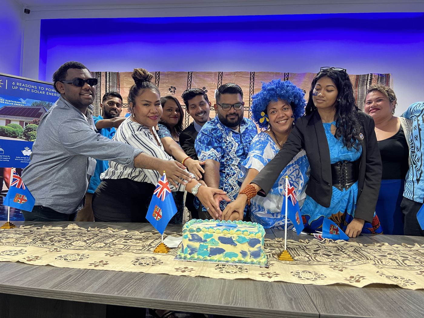 PCS team cutting the cake on Fiji Day at the Suva office